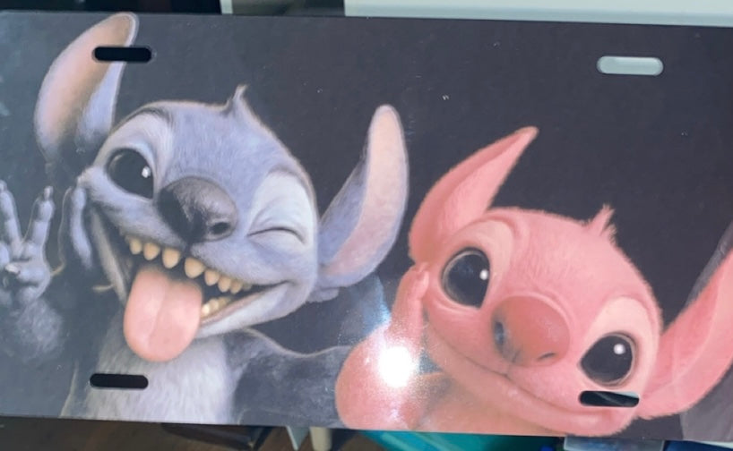 Mischievous Alien Couple Decorative License Plate